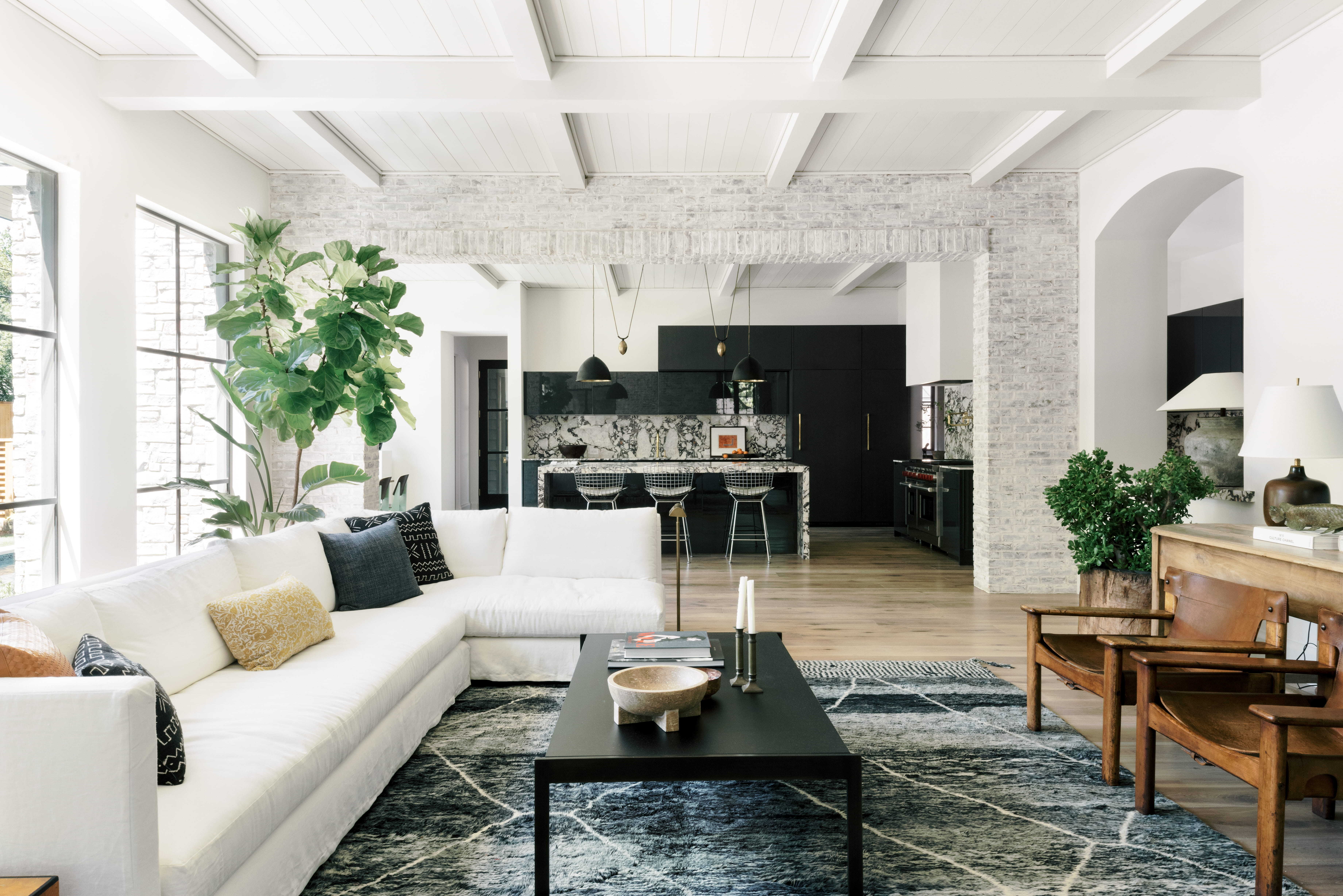 Open floor plan living room and kitchen with natural light, comfortable seating, and connected family spaces