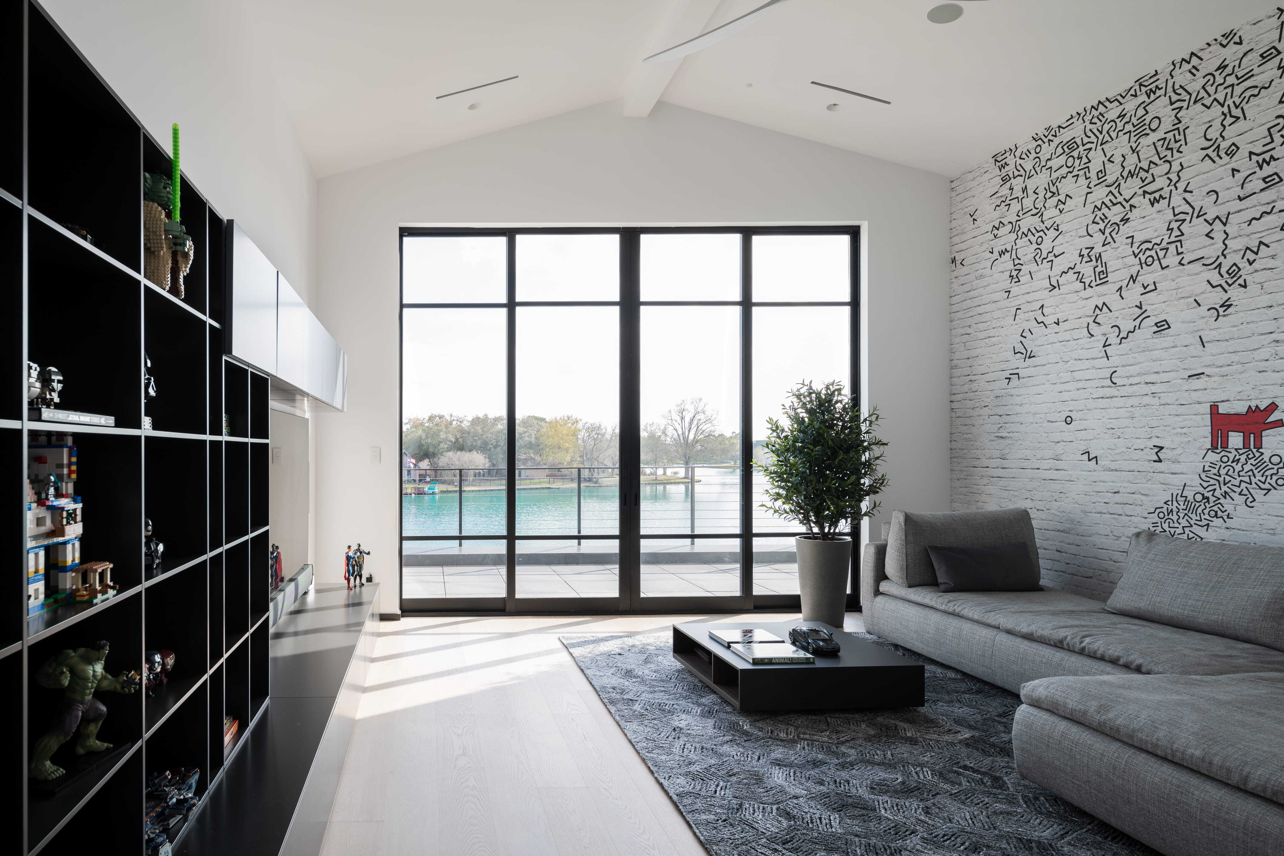 Bright multi-purpose playroom with built-in toy storage, large windows, and flexible family seating