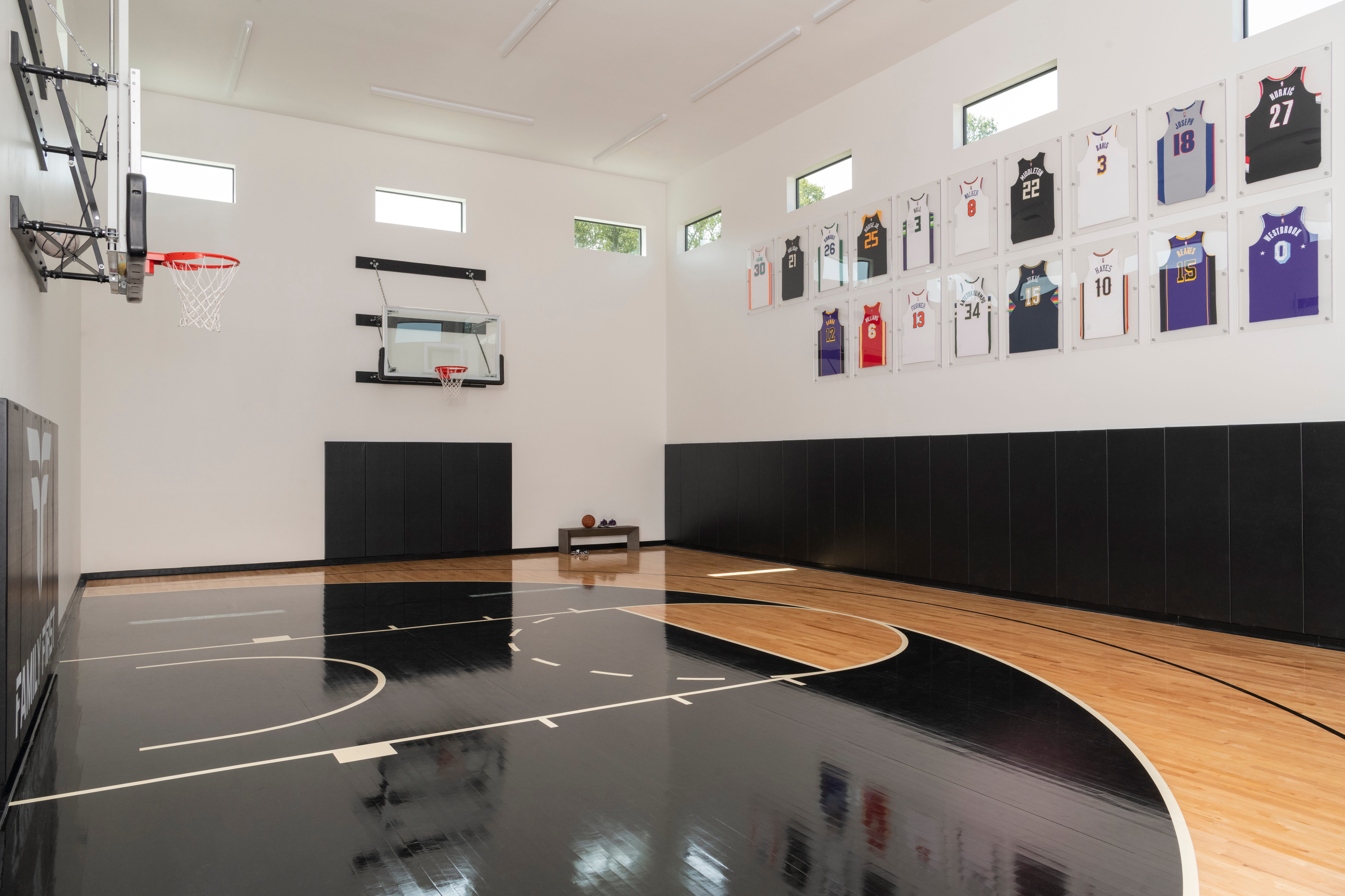Indoor basketball court in a custom home designed for active family recreation