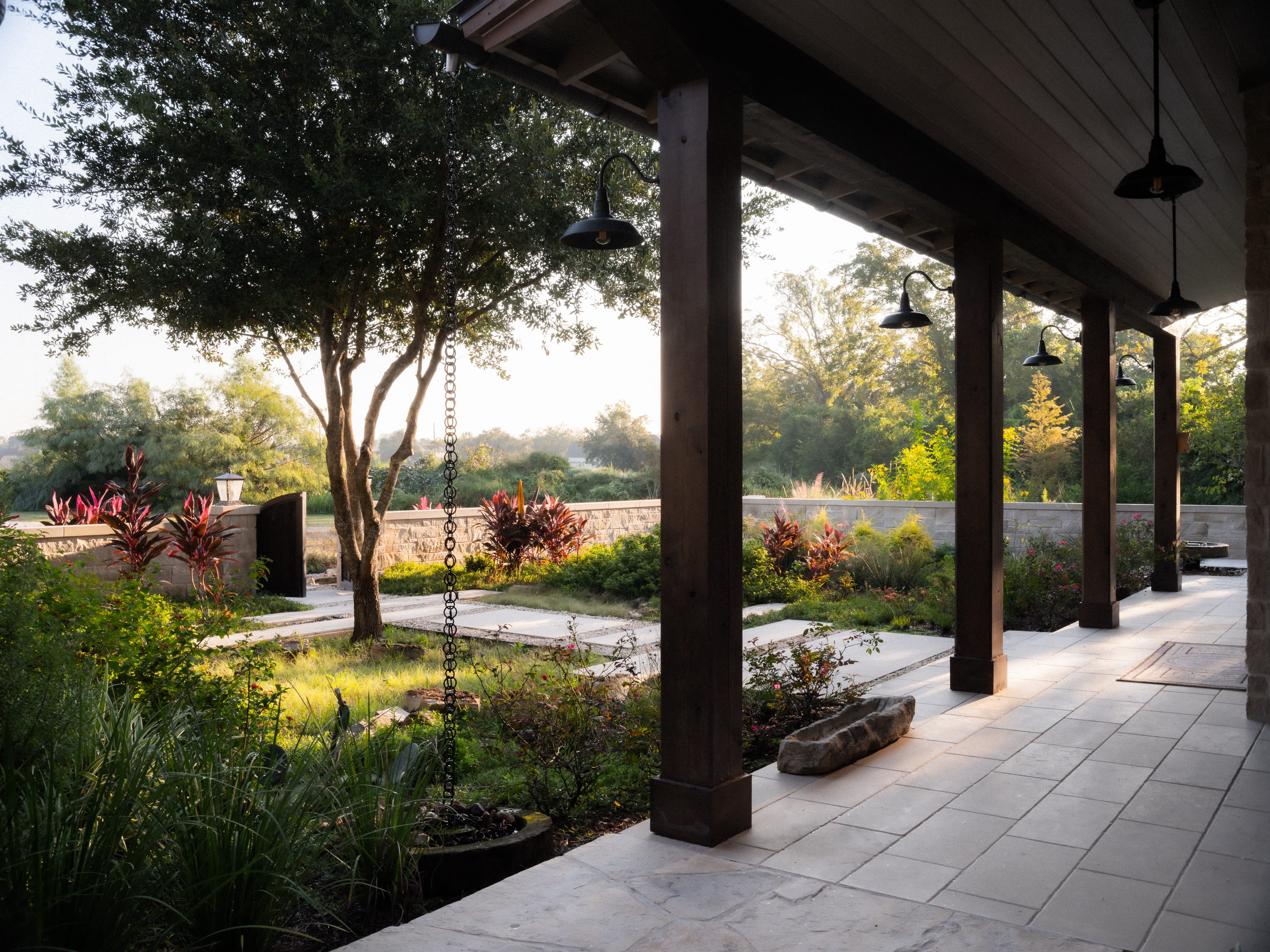 Covered walkway and landscaped outdoor space designed for a sustainable family-friendly custom home