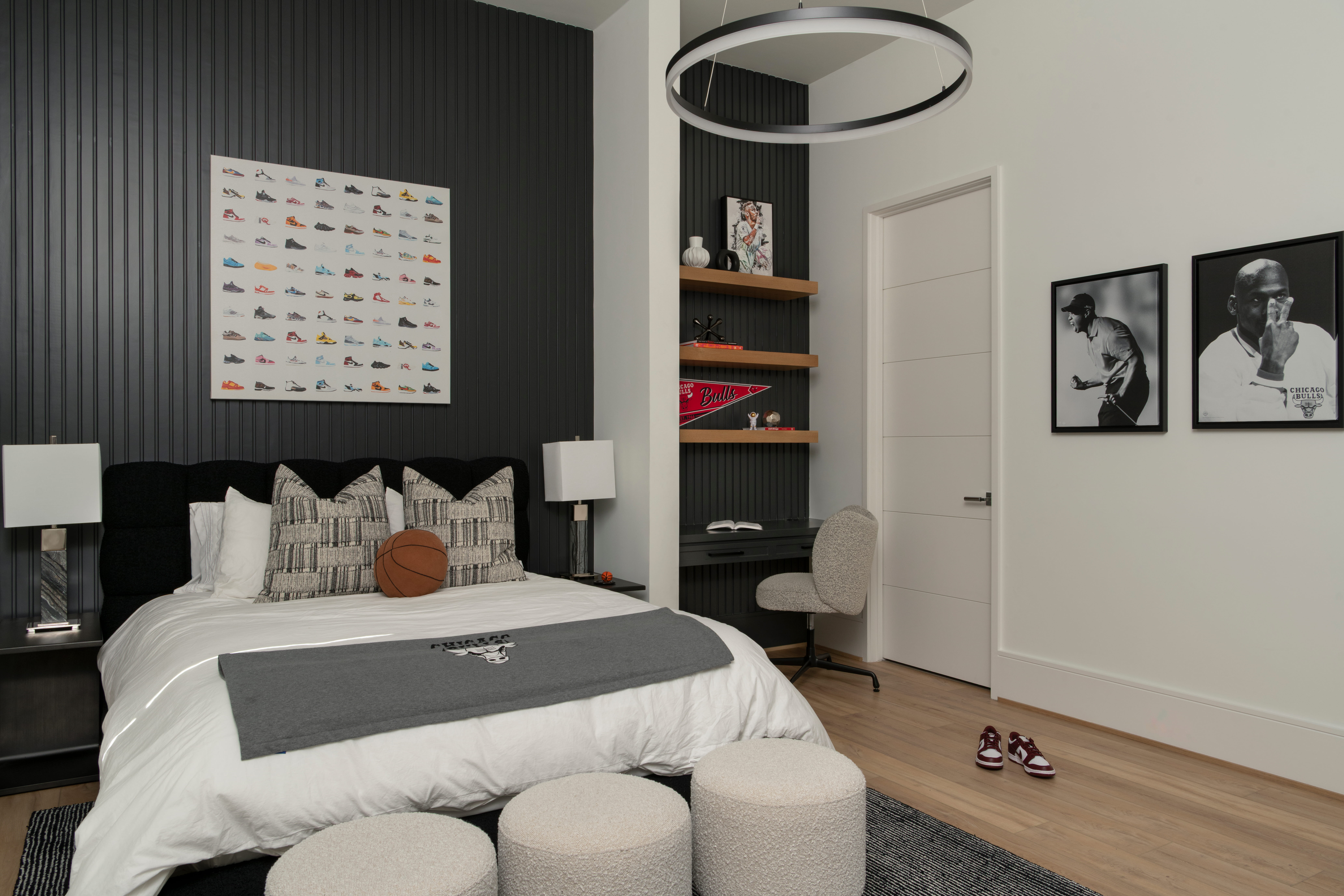 Personalized teen bedroom in a custom home with study desk, built-in shelves, and sports-inspired decor