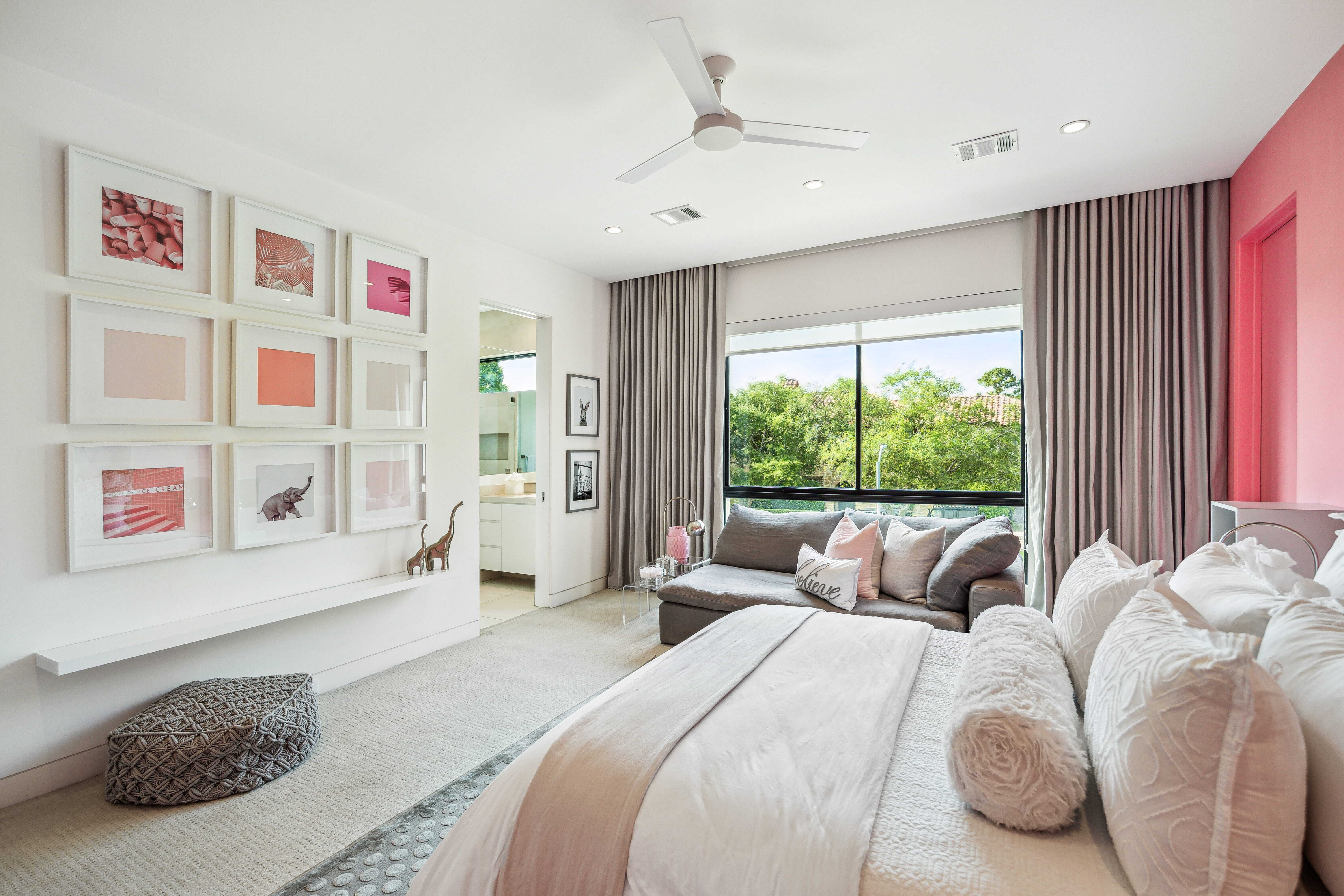 Bright children’s bedroom with sitting area, large window, and flexible layout in a custom family home