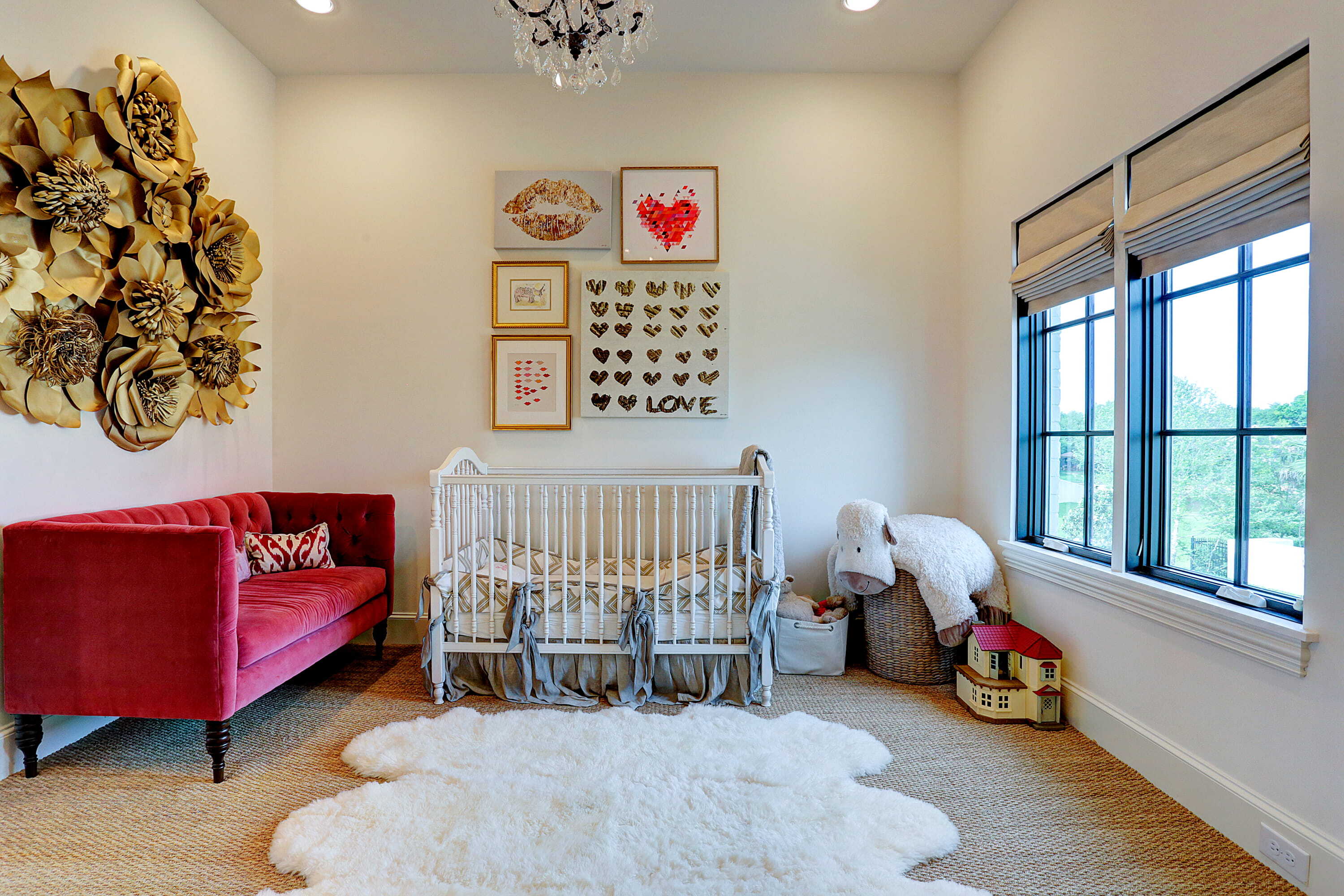 Custom nursery with crib, playful decor, large windows, and space designed for a growing family
