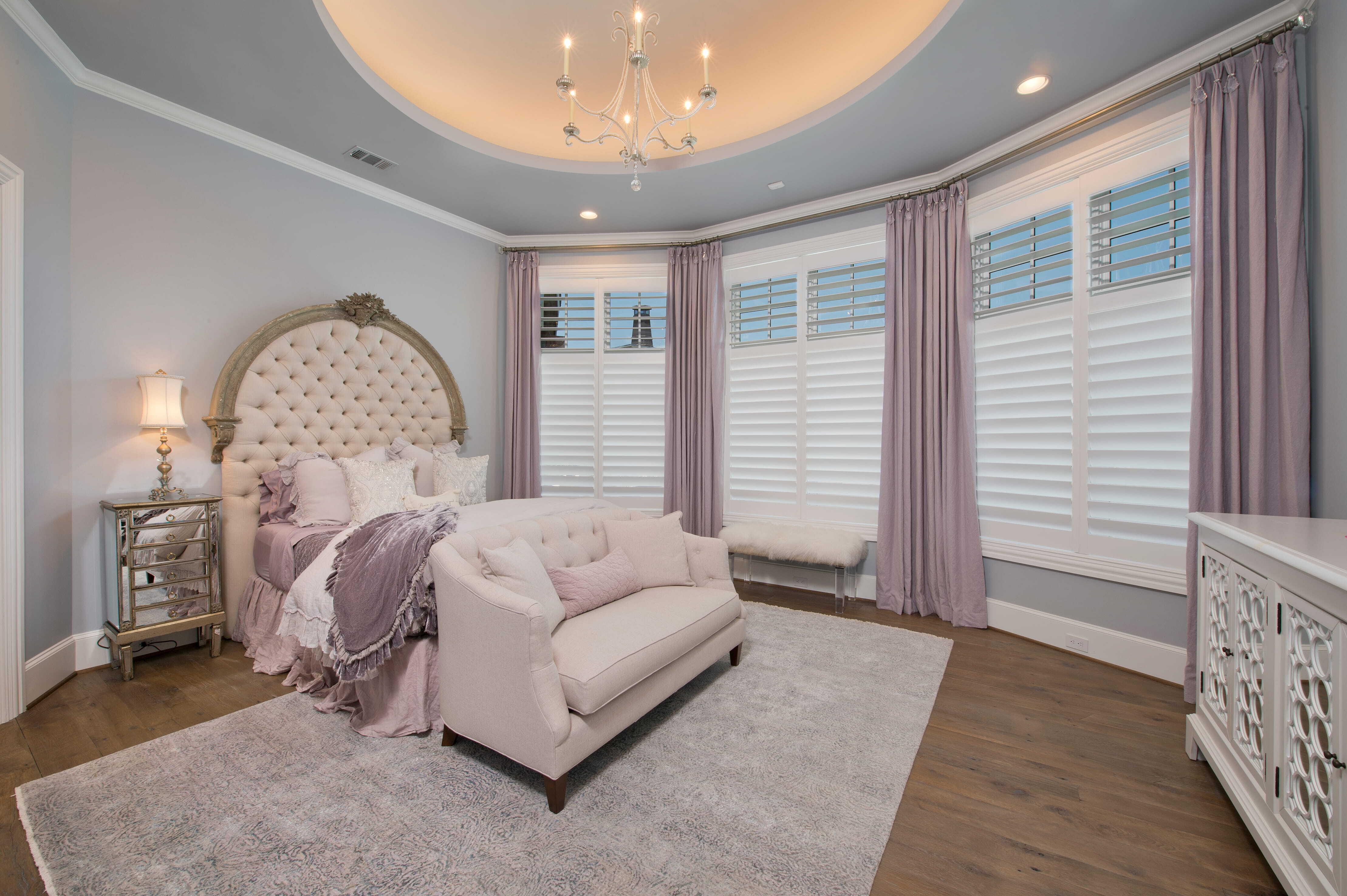 Elegant custom bedroom with large windows, seating area, and flexible design for long-term family living