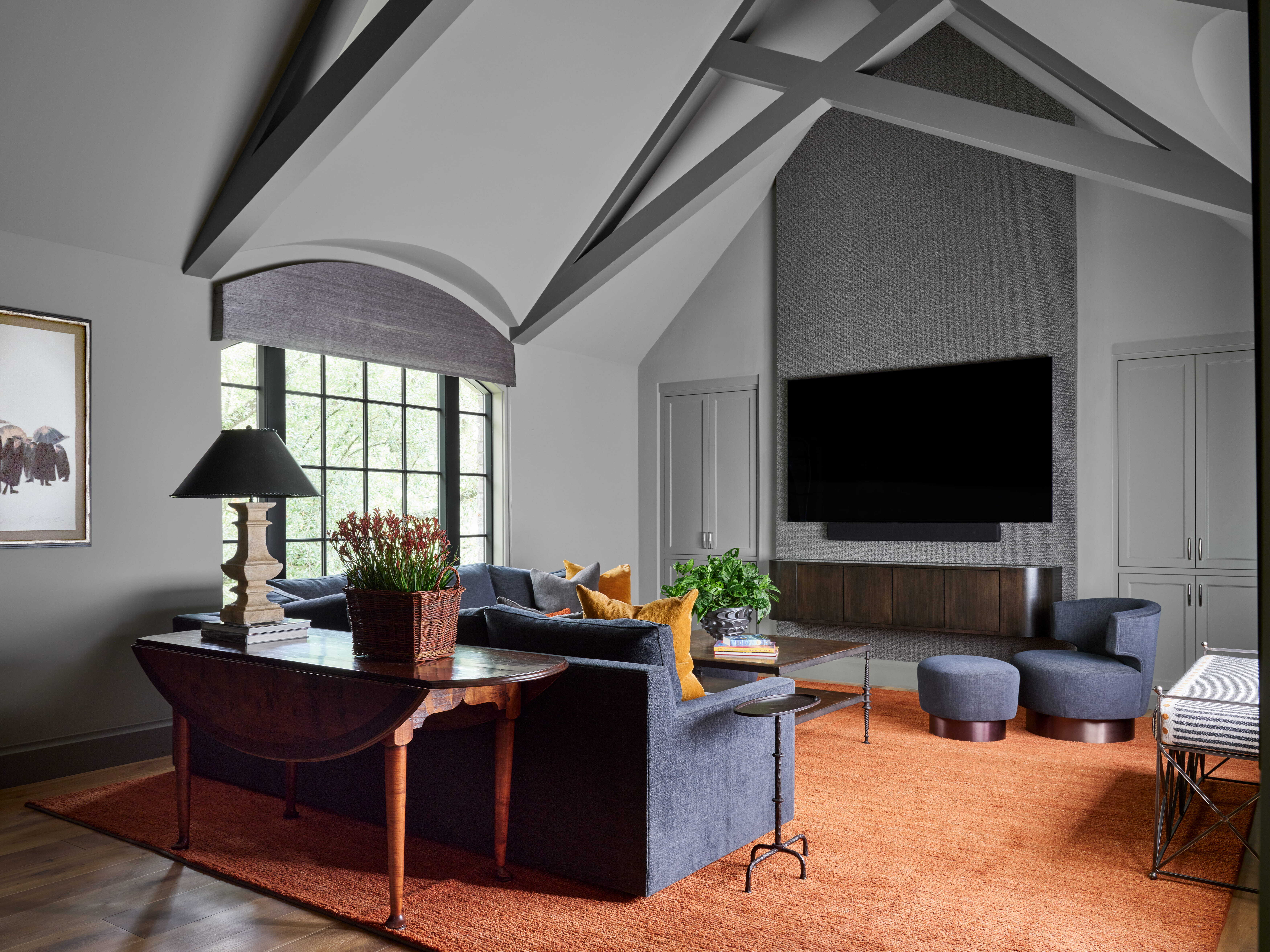 Multi-purpose family room with vaulted ceiling, built-in storage, and comfortable seating in a custom home