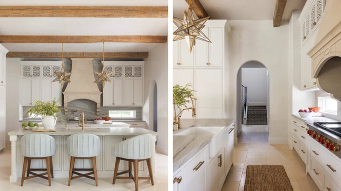 Luxury custom kitchen with exposed wood beams, marble countertops, cream cabinetry, and decorative pendant lighting.