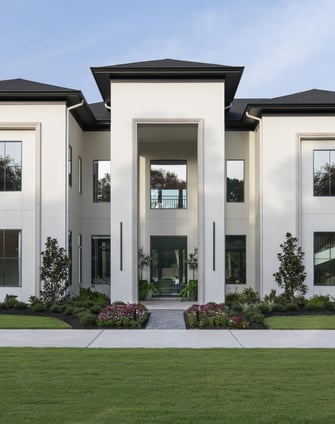 Modern exterior with clean lines, tall windows, manicured landscaping, and a symmetrical entry walkway.