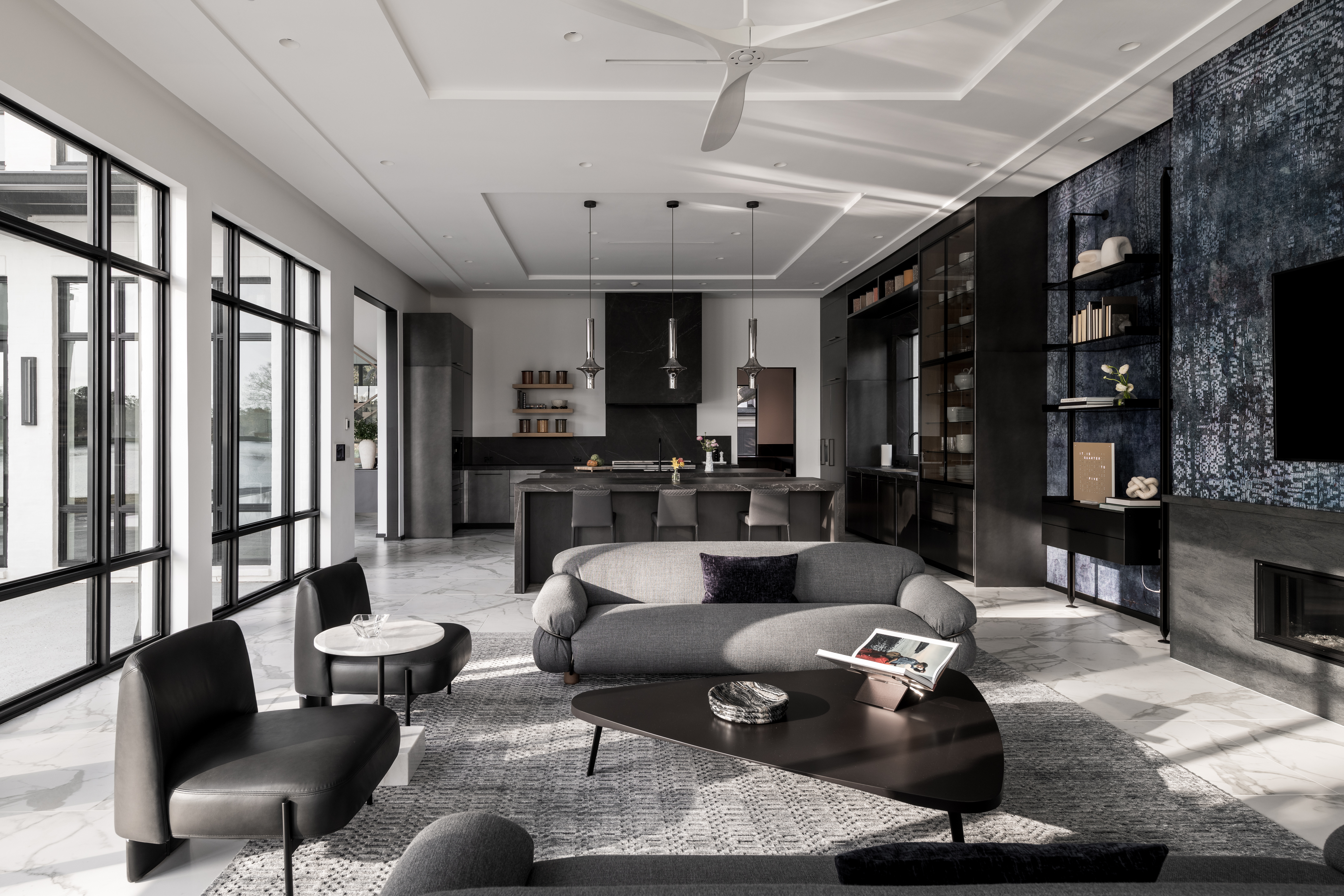 Contemporary custom home living room with black cabinetry, large windows, and modern furnishings.